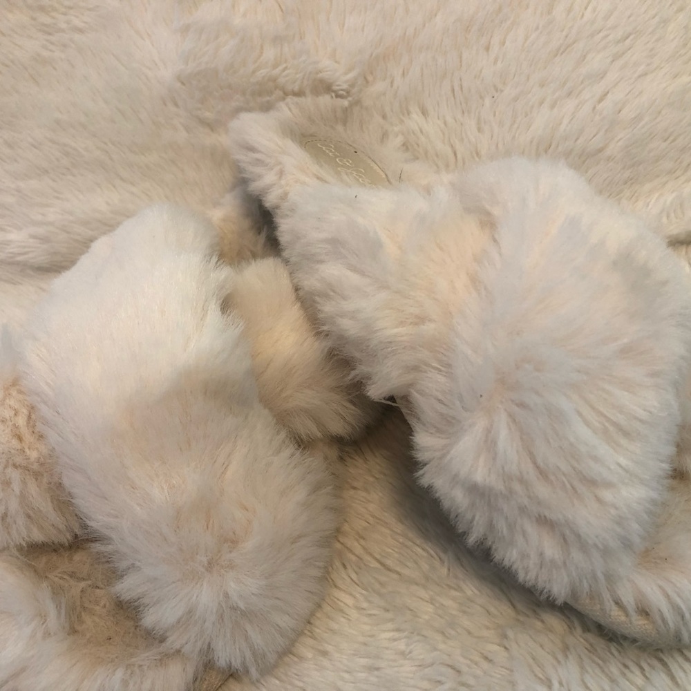 Soft white slippers from Target with a great color on the heel from wearing!